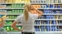 Frau versucht sich bei Masse an Produktangeboten im Supermarkt zurecht zu finden