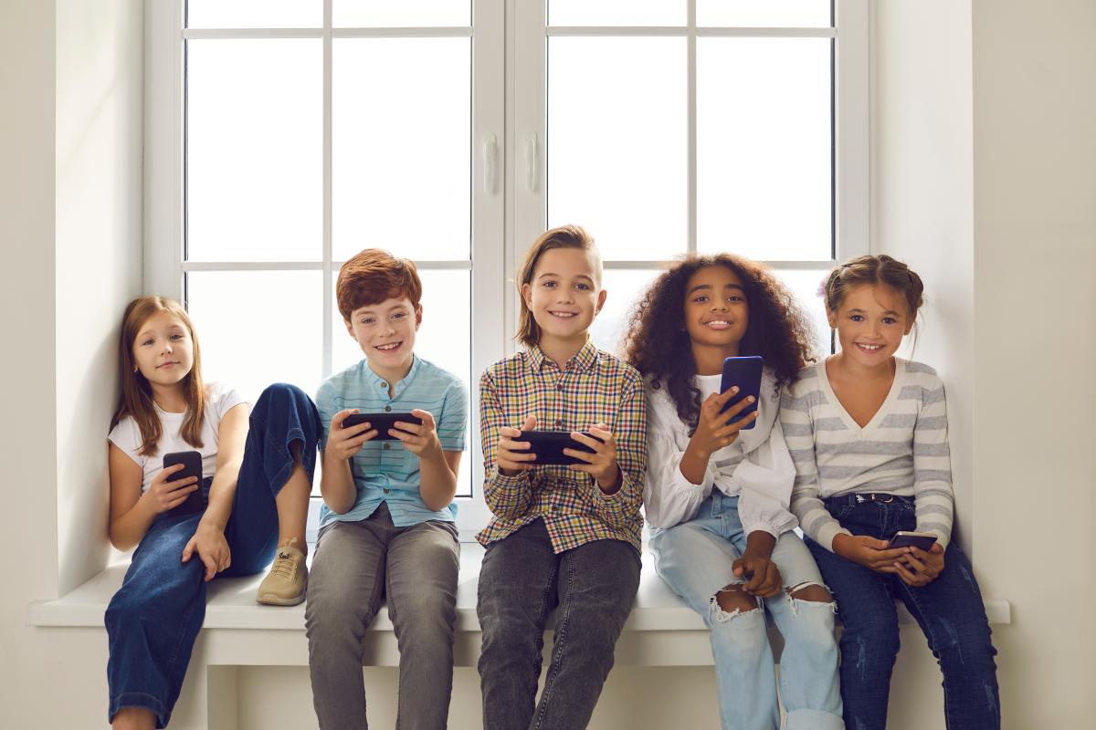 Kindergruppe mit Handys und Tablets